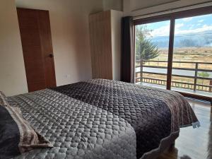 a bedroom with a large bed and a large window at Centro recreativo y Casa de campo in Orcotuna +26 photos