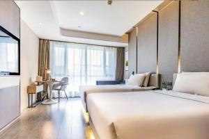 Postel nebo postele na pokoji v ubytování Atour Hotel Hohhot International Convention and Exhibition Center East University Street