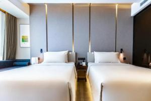 Postel nebo postele na pokoji v ubytování Atour Hotel Hohhot International Convention and Exhibition Center East University Street