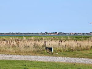 a field with a dirt road next to a grass field at 8 person holiday home in Storvorde-By Traum in Langesminde