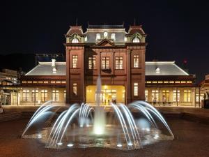 a building with a fountain in front of a building at APA Hotel Kokura Ekimae in Kitakyushu