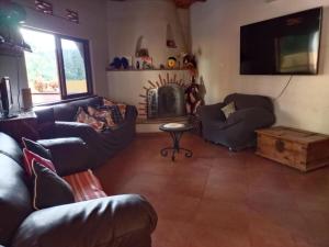 a living room with couches and a fire place at Paradise by the Playa in Los Ayala