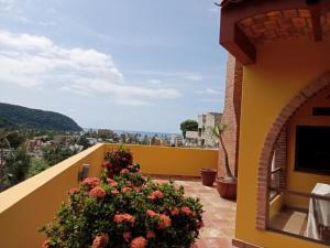 a balcony with a view of a city at Paradise by the Playa in Los Ayala