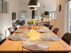 una gran mesa de madera en una habitación con sillas en 10 person holiday home in Jerup-By Traum, en Jerup 12 fotos más