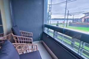 a room with a couch and a window with a view at HOM I 2D2B Parking, piscina temperada y gimnasio in Puerto Varas +53 photos