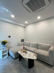 a living room with a couch and a table at HongHome Nguyễn Cửu Vân in Ho Chi Minh City