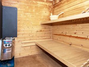 a sauna with a bench in a wooden wall at 5 star holiday home in Ringkøbing in Klegod
