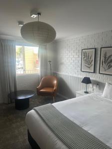 a hotel room with a bed and a chair at The Shamrock Hotel in Toowoomba
