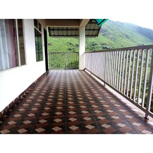 a balcony with a view of a mountain at Greens Vagamon in Vagamon