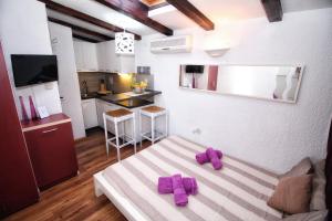 a living room with purple slippers on a couch at Apartments Nevija in Rovinj