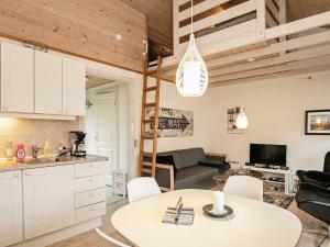 a kitchen and living room with a table and chairs at 4 person holiday home in Ærøskøbing in Ærøskøbing