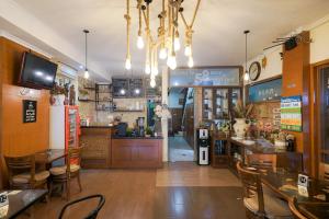 a restaurant with tables and chairs and a bar at Urbanview Hotel 58 Bintaro in Pondoklang +23 photos