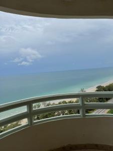 a view of the ocean from a balcony at Rayong VIP condo Thai style in Ban Phe +3 photos