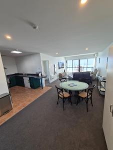 a living room with a table and a couch at Luxury Beach Escape - 6 Adams Ave Mt Maunganui in Mount Maunganui +23 photos
