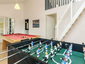 a group of toy people playing a game of ping pong at 10 person holiday home in Hadsund in Hadsund +34 photos