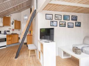 a tiny house with a staircase in a room at 5 person holiday home in Hovborg in Hovborg