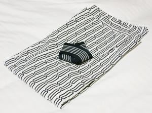 a black and white rug with a black object on it at Hotel Trend Nagano in Nagano