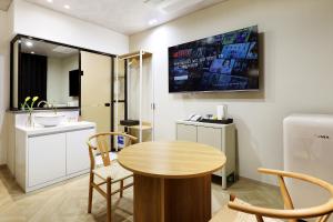a small kitchen with a table and a sink at Chuncheon Intro Family hotel in Chuncheon