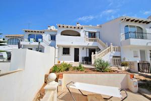 a large white house with a white fence at Vista Mar - modern, well-equipped bungalow in Moraira in Teulada +19 photos