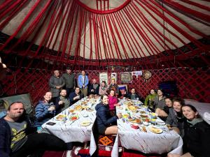 a group of people sitting at a table in a tent at Sayakat Eco Camp in Kaji-Say