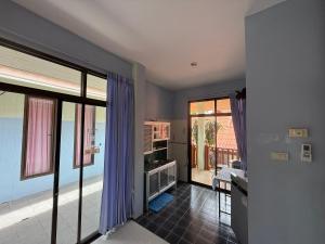 a living room with purple curtains and a view of the ocean at Sawasdee House in Lamai +69 photos