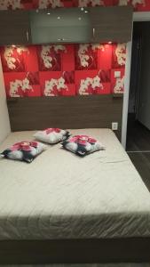 a bed with three pillows on top of it at Luxe Apartment Pana Green Residence Panagyurishte in Panagyurishte