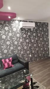 a living room with a black and white wall at Luxe Apartment Pana Green Residence Panagyurishte in Panagyurishte