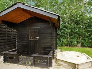 a wooden out house with a bench in front of it at Luxury Retreat with Spa - By Traum Ferienwohnungen in Hemmet