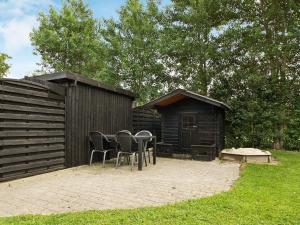 a patio with chairs and a table in front of a building at Luxury Retreat with Spa - By Traum Ferienwohnungen in Hemmet