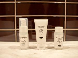 three bottles of sunscreen sitting on a bathroom counter at illi Jam Shinsaibashi in Osaka