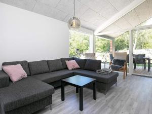 a living room with a couch and a table at 8 person holiday home in Læsø-By Traum in Læsø +21 photos
