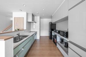a kitchen with a sink and a counter at The Vertex in Asahikawa +143 photos