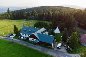 an aerial view of a house with a blue roof at Chata Buchtovna in Rejdice