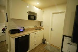 a small kitchen with a sink and a microwave at modern studio- 7 min from aswan station in Aswan +7 photos