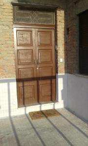 a large wooden door on the side of a building at 3 vani 700 Mt mare e 3000 Mt da Capo D'Orlando in Naso