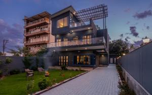 una casa con un jardín delante de ella en SaffronStays Tarangini by Ganges, en Rishīkesh