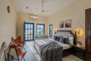 a bedroom with a large bed in a room at SaffronStays Tarangini by Ganges in Rishīkesh +44 photos