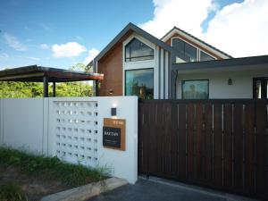 a house with a fence and a sign on it at Private three-bedroom home in Chiang Mai