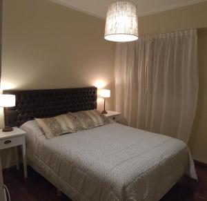 - une chambre avec un lit, 2 tables de nuit et 2 lampes dans l'établissement Apartment Lam62, à Bahía Blanca
