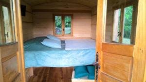 a small bed in a small room in a tiny house at Hôtel Restaurant L Orée du Vercors in Montmaur-en-Diois