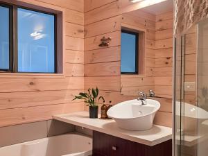 a bathroom with a sink and a bath tub at Whare Puwaha - River Mouth House in Glenorchy +18 photos