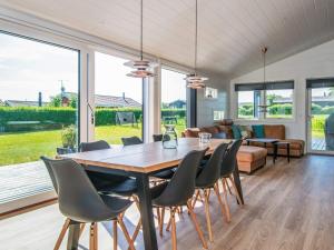a dining room with a large wooden table and chairs at 5 star holiday home in Hejls in Hejls