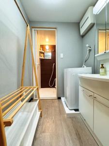 a bathroom with a sink and a staircase in a house at Home Stroy in Tokyo-VENTI Okachimachi 東京屋語 in Tokyo