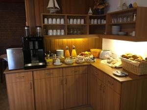 a kitchen with a counter with a coffee maker and fruit at Hotel Nordseegruß in Norddeich