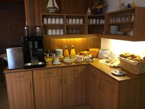 ノルトダイヒにあるHotel Nordseegrußのキッチン(コーヒーメーカー、フルーツ付きのカウンター付)