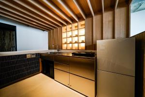 a kitchen with a sink and a refrigerator at Alternest Kamakura in Kamakura