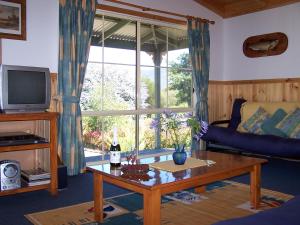 een woonkamer met een bank en een salontafel bij Sunburst Retreat in Eildon