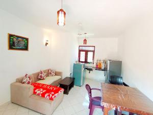 a living room with a couch and a table at Sea Side Bay House in Weligama