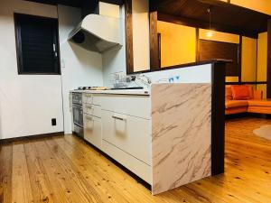 a kitchen with a sink and a stove top oven at Shiki no Iori - Vacation STAY 19533 in Itoshima +20 photos