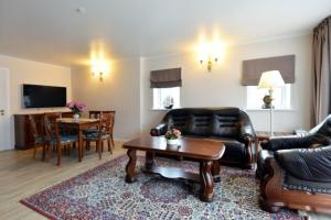 a living room with a couch and a table at Harmony Park Nida House in Nida